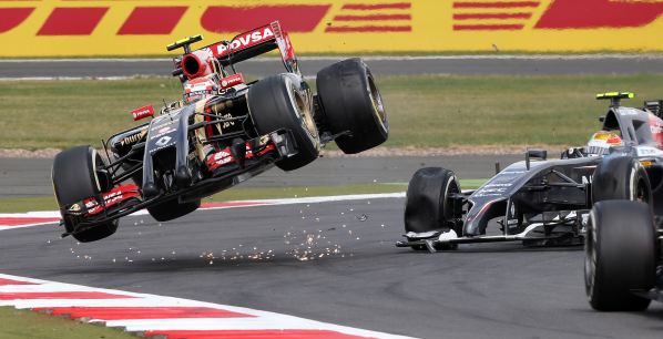 Lotus F1 team driver Pastor Maldonado of Venezuela collides with Sauber driver Esteban Gutierrez of Mexico during the British Grand Prix at the Silverstone Race Circuit, central England