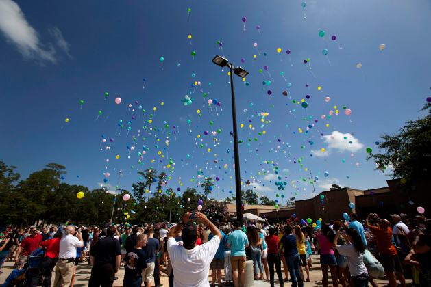 Balloons are released during a memorial service for members of the Stay family who were murdered Wednesday in Spring, Texas