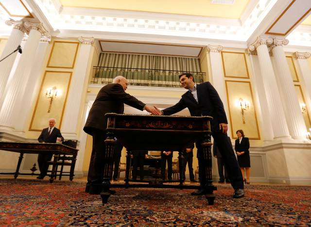 Tsipras shakes hands with Greek President Papoulias during his swearing-in ceremony as Greece's first leftist Prime Minister, at the Presidential palace in Athens