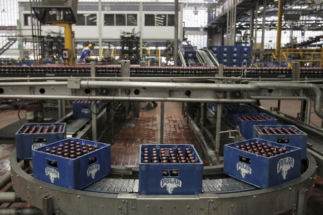 Beer boxes are seen at a production line at a Polar brewery in Maracaibo, Venezuela July 13, 2015. Venezuela's Labor Ministry has ordered workers to lift a strike at beer maker Polar that had halted two of its breweries and restricted supplies of beer in the South American nation. Polar, the country's largest privately owned company, produces as much as 80 percent of the beer consumed in the country, which has historically been among the world's top per capita consumers of beer. Picture taken on July 13, 2015. REUTERS/Isaac Urrutia