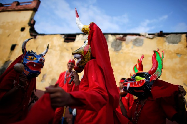 The "Diablos Danzantes" of Yare wear masks as they perform a dance to mark the Feast of Corpus Christi in San Francisco de Yare