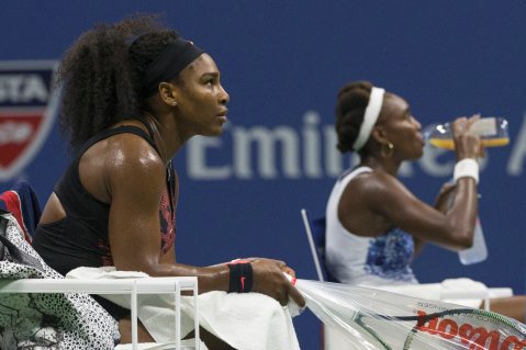 Serena Williams of the U.S. and her sister and compatriot Venus Williams rest between games during their quarterfinals match at the U.S. Open Championships tennis tournament in New York