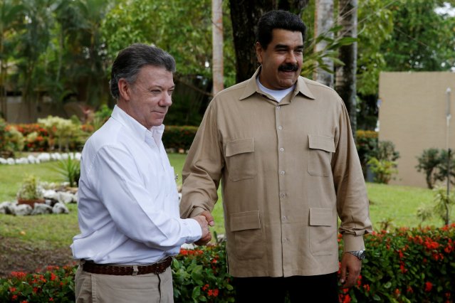 Venezuela's President Maduro and Colombia's President Santos shake hands during their meeting at Macagua Hydroelectric compound in Puerto Ordaz