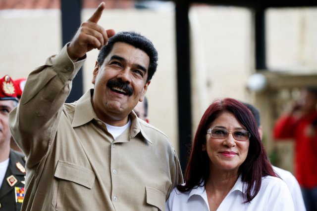 Venezuela's President Maduro talks to his wife Cilia Flores while they wait the arrival of Colombia's President Santos at Macagua Hydroelectric compound in Puerto Ordaz
