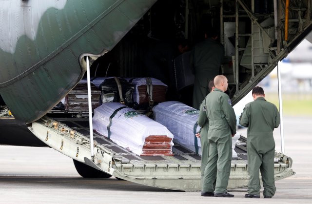 Coffins with the remains of Brazilian victims who died in an accident of the plane that crashed into the Colombian jungle with Brazilian soccer team Chapecoense are pictured, at the airport from where the bodies will be flown home to Brazil, in Medellin, Colombia December 2, 2016. REUTERS/Jaime Saldarriaga