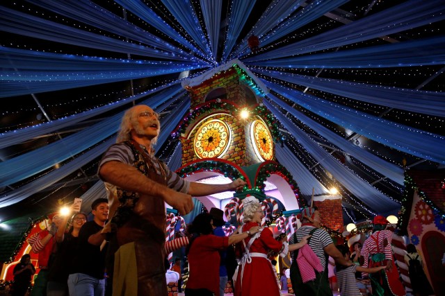 People dance with performers at a Christmas attraction in Universal Studios Singapore December 12, 2016. REUTERS/Edgar Su