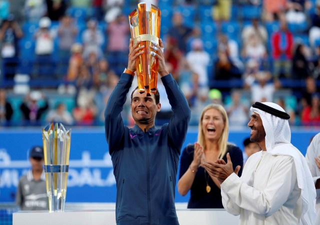 Tennis - Mubadala World Tennis Championship - Rafael Nadal of Spain v David Goffin of Belgium - Abu Dhabi, UAE - 31/12/16 - Rafael Nadal of Spain celebrates after receiving his trophy from Sheikh Nahyan bin Zayed Al Nahyan, Chairman of Abu Dhabi Sports Council. REUTERS/Ahmed Jadallah