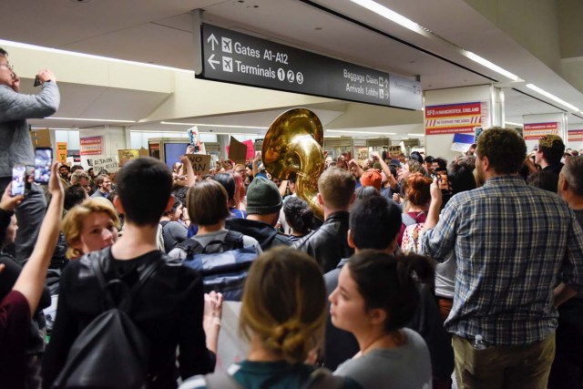 Demonstrators yell slogans during anti-Donald Trump immigration ban protests inside Terminal 4 at San Francisco International Airport in San Francisco, California, U.S., January 28, 2017. REUTERS/Kate Munsch