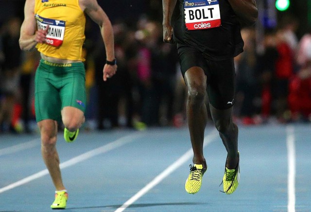 Jamaica's Olympic champion Usain Bolt runs with his shoelaces untied next to Australia's Alex Hartmann during the final night of the Nitro Athletics series at the Lakeside Stadium in Melbourne, Australia, February 11, 2017. REUTERS/Hamish Blair