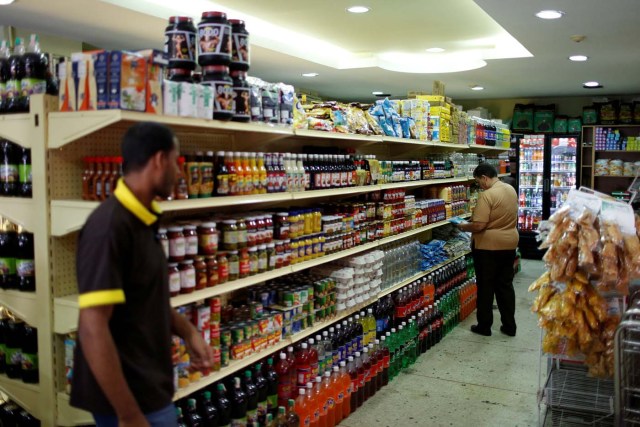 People look for groceries and goods at a supermarket in Caracas, Venezuela March 9, 2017. REUTERS/Carlos Garcia Rawlins