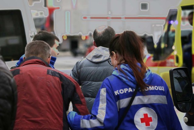 An injured person is helped by emergency services outside Sennaya Ploshchad metro station, following explosions in two train carriages at metro stations in St. Petersburg, Russia April 3, 2017. REUTERS/Anton Vaganov