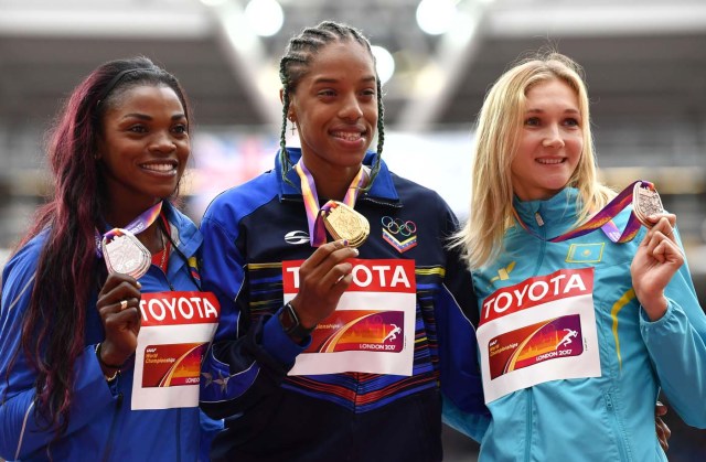 Silver medallist Colombia's Caterine Ibarguen (L), gold medallist Venezuela's Yulimar Rojas (C) and bronze medallist Kazakhstan's Olga Rypakova (R) pose on the podium during the victory ceremony for the women's triple jump athletics event at the 2017 IAAF World Championships at the London Stadium in London on August 8, 2017. / AFP PHOTO / Andrej ISAKOVIC
