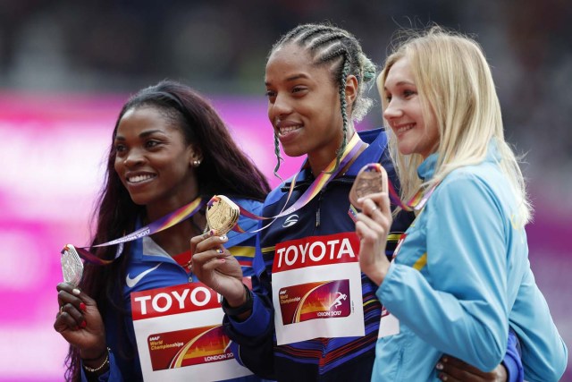 Silver medallist Colombia's Caterine Ibarguen (L), gold medallist Venezuela's Yulimar Rojas (C) and bronze medallist Kazakhstan's Olga Rypakova (R) pose on the podium during the victory ceremony for the women's triple jump athletics event at the 2017 IAAF World Championships at the London Stadium in London on August 8, 2017. / AFP PHOTO / Adrian DENNIS