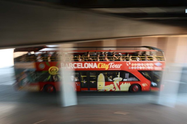 A touristic bus of Barcelona passes under a tunnel in Barcelona on August 21, 2017. Spanish police said on August 21, 2017 that they have identified the driver of the van that mowed down pedestrians on the busy Las Ramblas boulevard in Barcelona, killing 13. The 22-year-old Moroccan is believed to be the last remaining member of a 12-man cell still at large in Spain or abroad, with the others killed by police or detained over last week's twin attacks in Barcelona and the seaside resort of Cambrils that claimed 14 lives, including a seven-year-old boy. / AFP PHOTO / Josep LAGO