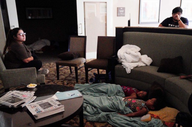 Children sleep in a hotel lobby waiting out Hurricane Harvey in Victoria, Texas, August 26, 2017. REUTERS/Rick Wilking