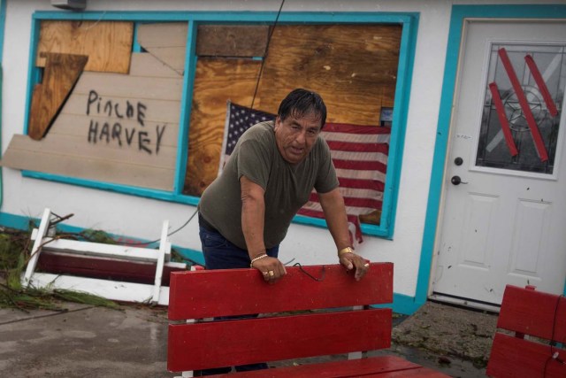 Business owner and resident Carlos Lopez assesses damage from Hurricane Harvey after arriving at his electronics repair shop in Rockport, Texas, U.S. August 26, 2017. REUTERS/Adrees Latif