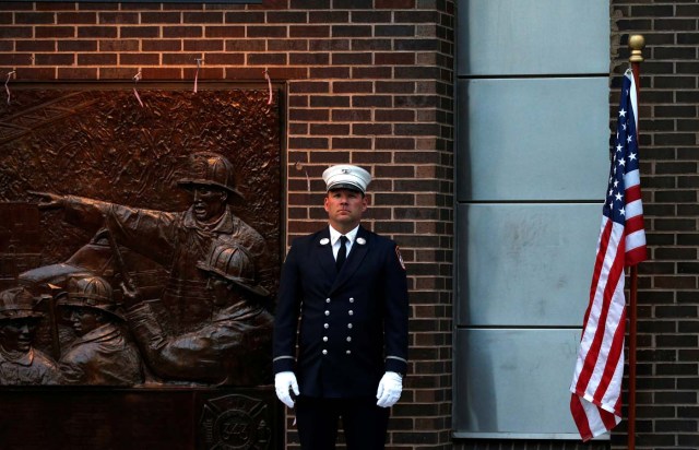 A New York City Fire Department (FDNY) firefighter stands outside Engine10/Ladder10 fire station near the National September 11 Memorial and Museum during ceremonies marking the 16th anniversary of the September 11, 2001 attacks in New York, U.S. September 11, 2017. REUTERS/Brendan McDermid