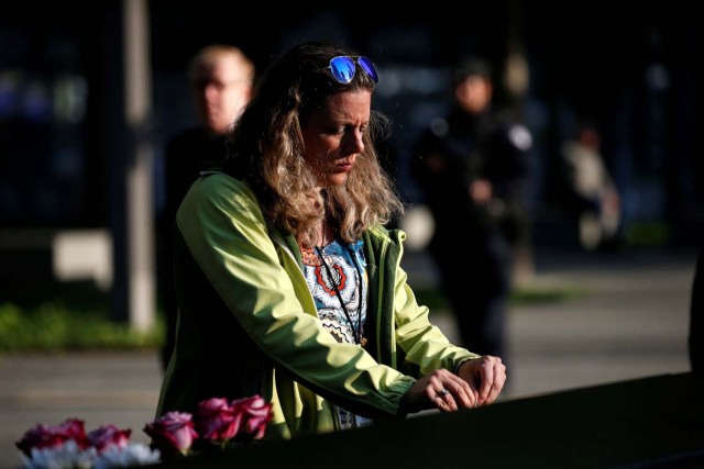 A woman pauses at the edge of the South reflecting pool at the National September 11 Memorial and Museum during ceremonies marking the 16th anniversary of the September 11, 2001 attacks in New York, U.S. September 11, 2017. REUTERS/Brendan McDermid