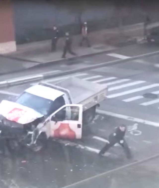A police officer is seen running away from the pickup truck that mowed down pedestrians and cyclists on a bike path alongside the Hudson River after the attack, in New York City, NY, U.S., in this still image from a video obtained from social media October 31, 2017. TAWHID KABIR XISAN via REUTERS THIS IMAGE HAS BEEN SUPPLIED BY A THIRD PARTY. MANDATORY CREDIT. NO RESALES. NO ARCHIVES. MUST ON SCREEN COURTESY TAWHID KABIR XISAN