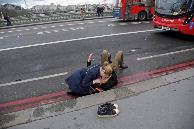 A woman assists an injured person after an incident on Westminster Bridge in London, Britain March 22, 2017.  REUTERS/Toby Melville/File Photo      SEARCH "POY GLOBAL" FOR THIS STORY. SEARCH "REUTERS POY" FOR ALL BEST OF 2017 PACKAGES.    TPX IMAGES OF THE DAY