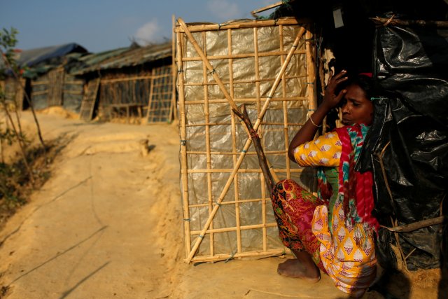 A Rohingya refugee woman sits at the door of her temporary shelter at the Thangkali refugee camp near Cox's Bazar, Bangladesh December 21, 2017. REUTERS/Alkis Konstantinidis