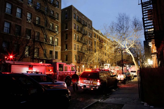 New York Police Department (NYPD) officers and Fire Department of New York (FDNY) personnel work on the scene of an apartment fire in Bronx, New York, U.S., December 29, 2017. REUTERS/Eduardo Munoz