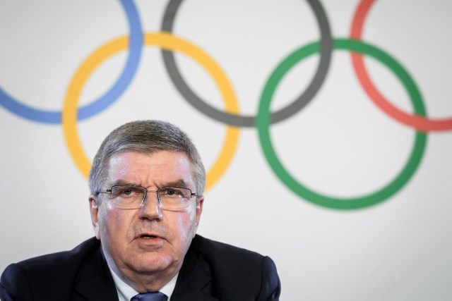 International Olympic Committee (IOC) President Thomas Bach attends a press conference following an executive meeting on Russian doping, on December 5, 2017 in Lausanne. Russia were banned from the 2018 Olympics on December 5 over state-sponsored doping but the International Olympic Committee said Russian competitors would be able to compete "under strict conditions". / AFP PHOTO / Fabrice COFFRINI