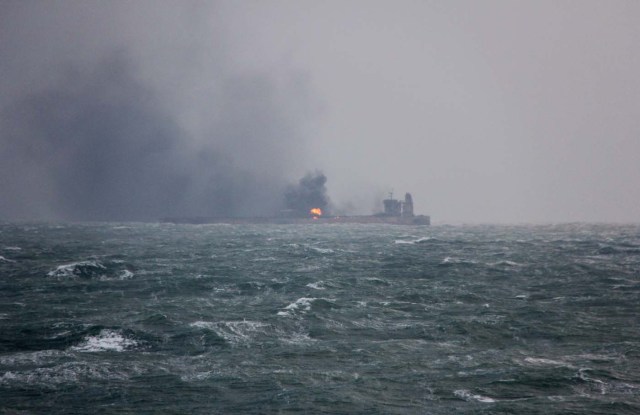 Smoke is seen from Panama-registered Sanchi tanker carrying Iranian oil that caught ablaze after it collided with a Chinese freight ship in the East China Sea, in this January 9, 2018 handout picture released by China's Ministry of Transport. China's Ministry of Transport/Handout via REUTERS ATTENTION EDITORS - MANDATORY CREDIT. NO RESALES. NO ARCHIVE. THIS PICTURE WAS PROCESSED BY REUTERS TO ENHANCE QUALITY. AN UNPROCESSED VERSION HAS BEEN PROVIDED SEPARATELY.