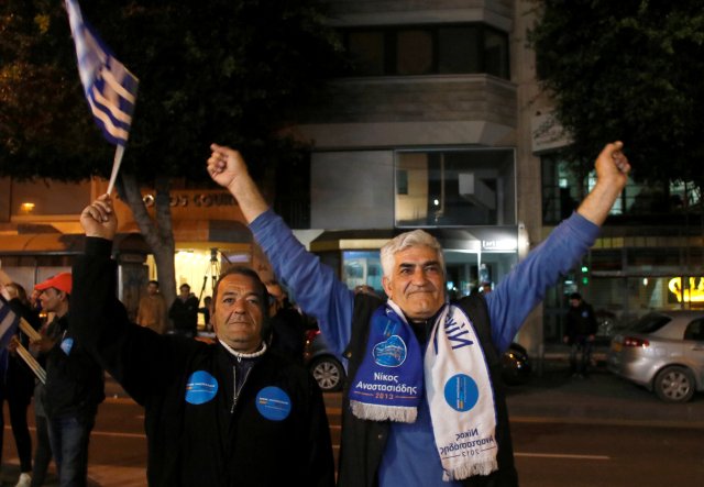 Supporters of the incumbent president Nicos Anastasiades celebrate on the street after announcement of exit polls during the second round of the presidential election in Nicosia, Cyprus, February 4, 2018. REUTERS/Yiannis Kourtoglou