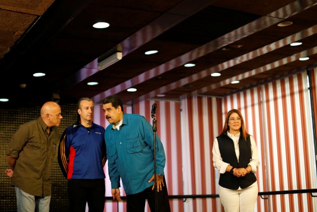 Venezuela's President Nicolas Maduro (2nd R) speaks with Venezuela's Communications and Information Minister Jorge Rodriguez (L) and Venezuela's Vice President Tareck El Aissami, next to his wife Cilia Flores, as they arrive for an event with supporters in Caracas, Venezuela February 3, 2018. REUTERS/Marco Bello