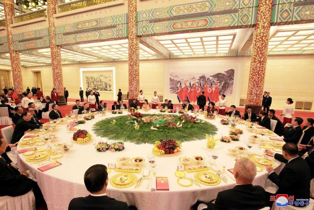 REFILE - ADDING CITY North Korean leader Kim Jong Un and wife Ri Sol Ju, and Chinese President Xi Jinping and wife Peng Liyuan attend a banquet, as Kim Jong Un paid an unofficial visit to Beijing, China, in this undated photo released by North Korea's Korean Central News Agency (KCNA) in Pyongyang March 28, 2018. KCNA/via Reuters ATTENTION EDITORS - THIS IMAGE WAS PROVIDED BY A THIRD PARTY. REUTERS IS UNABLE TO INDEPENDENTLY VERIFY THIS IMAGE. NO THIRD PARTY SALES. NOT FOR USE BY REUTERS THIRD PARTY DISTRIBUTORS. SOUTH KOREA OUT. NO COMMERCIAL OR EDITORIAL SALES IN SOUTH KOREA.