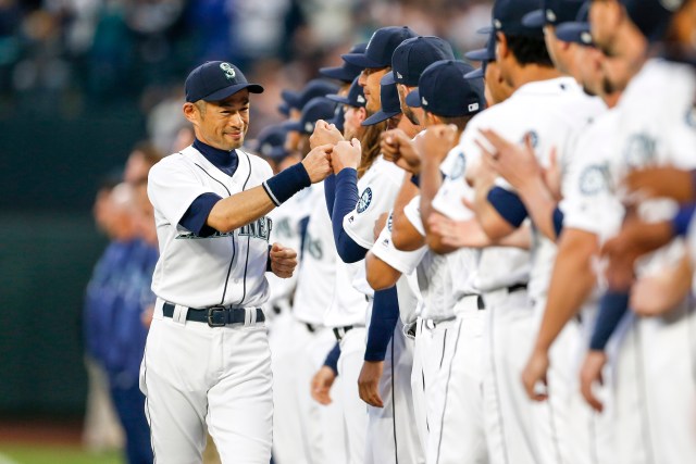 Mar 29, 2018; Seattle, WA, USA; Seattle Mariners left fielder Ichiro Suzuki (51) (left) greets teammates during player introductions before a game against the Cleveland Indians at Safeco Field. Mandatory Credit: Joe Nicholson-USA TODAY Sports