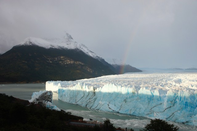 A rainbow is seen over the Perito Moreno glacier at Parque Nacional Los Glaciares near El Calafate, in the Argentine province of Santa Cruz, on March 12, 2018. An arch of ice formed at the tip of the Perito Moreno, between the glacier and the shore of Argentino lake collapsed into the water overnight. A natural display that happens just once every several years. Such arches form roughly every two to four years, when the glacier forms a dam of ice that cuts off the flow of water around it into the lake -- until the water breaks through, opening up a steadily wider tunnel that eventually becomes a narrow arch... and then collapses. / AFP PHOTO / WALTER DIAZ