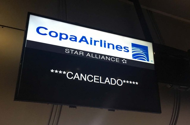 A screen of Panama's Copa Airlines announces a flight has been cancelled at Caracas' international airport on April 6, 2018 after Venezuela suspended flights of the company in an escalating diplomatic row. Panama on April 5 ordered Venezuela's ambassador out and recalled its own envoy to the country as Caracas imposed sanctions on senior Panamanian officials and suspended flights in an escalating diplomatic row. At issue is Panama's alignment with other Latin American countries as well as the European Union, Canada and the United States that have taken measures against President Nicolas Maduro's and his government on the grounds that he is undemocratically tightening his hold on power. / AFP PHOTO / Federico PARRA