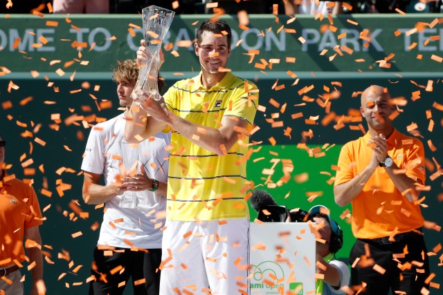 Apr 1, 2018; Key Biscayne, FL, USA; John Isner of the United States celebrates with the Butch Buchholz championship trophy after his match against Alexander Zverev of Germany (L) in the men's singles final of the Miami Open at Tennis Center at Crandon Park. 6-7(4), 6-4, 6-4. Mandatory Credit: Geoff Burke-USA TODAY Sports