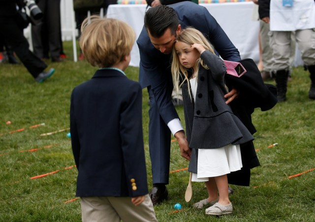 Donald Trump Jr. helps his daughter Chloe Trump participate in the egg roll during the annual White House Easter Egg Roll on the South Lawn of the White House in Washington, April 2, 2018. REUTERS/Leah Millis