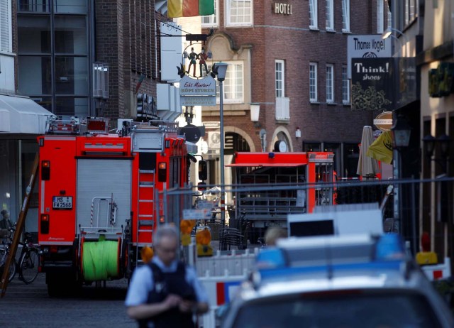 Police vehicles and fire engines in a street near a place where a man drove a van into a group of people sitting outside a popular restaurant in the old city centre of Muenster, Germany, April 7, 2018.   REUTERS/Leon Kuegeler