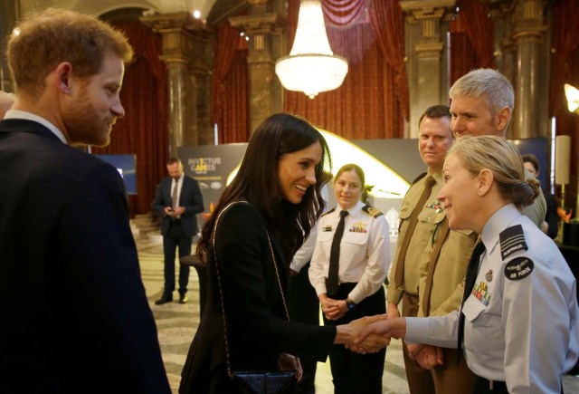 Britain's Prince Harry and Meghan Markle greet members of the Australian Defence Force during a reception celebrating the forthcoming Invictus Games Sydney 2018, hosted by Malcolm Turnbull, Prime Minister of Australia, and his wife Lucy Turnbull, at Australia House in London, Britain April 21, 2018. Alastair Grant/Pool via Reuters