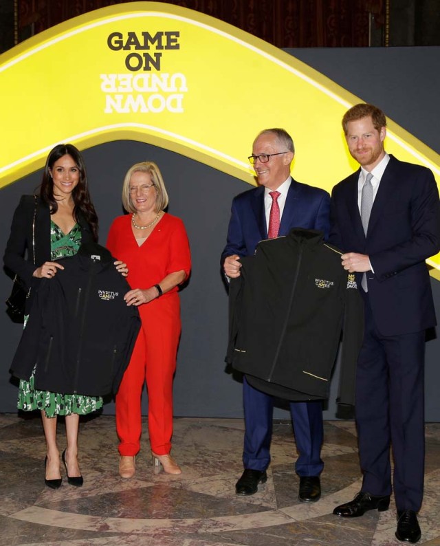 Britain's Prince Harry and Meghan Markle receive Invictus Games jackets during a reception celebrating the forthcoming Invictus Games Sydney 2018, hosted by Malcolm Turnbull, Prime Minister of Australia, and his wife Lucy Turnbull, at Australia House in London, Britain April 21, 2018. Alastair Grant/Pool via Reuters