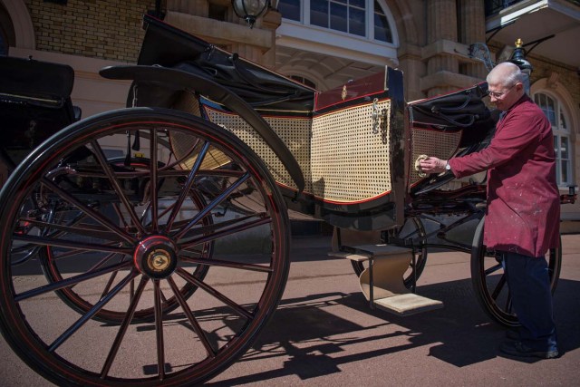 Martin Oates, Senior Carriage Restorer, polishes the Ascot Landau, which will be used in the case of dry weather at the wedding of Prince Harry and Meghan Markle, at the Royal Mews at Buckingham Palace, London. Picture taken May 1, 2018. REUTERS/Victoria Jones/Pool
