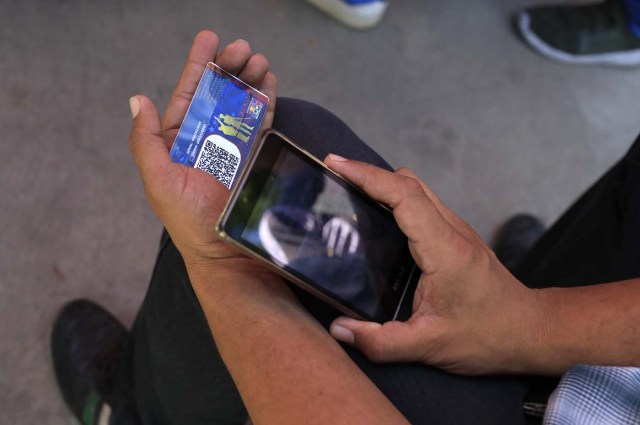 An identification card is checked at a "Red Point," an area set up by President Nicolas Maduro's party to verify that people cast their votes, during the presidential election in Caracas, Venezuela, May 20, 2018. REUTERS/Marco Bello